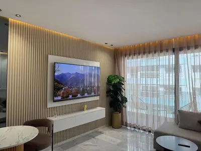 a living room with a television on a wall at Stylish Apartment with a seaview 9 in Casablanca