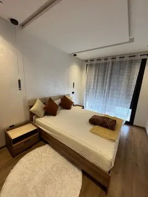 a bedroom with a large bed and a window at Studio au Parc Mohammedia in Mohammedia