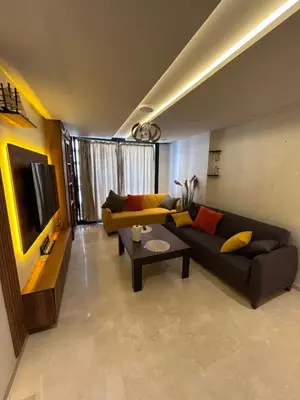 a living room with a couch and a table at Studio au Parc Mohammedia in Mohammedia