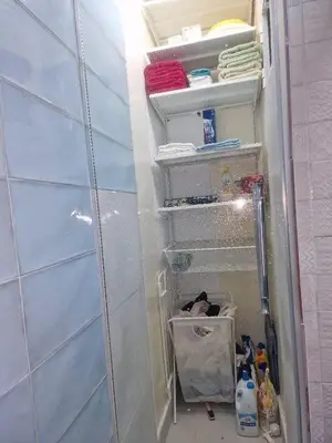 a bathroom with a closet with white shelves at Votre Appartement neuf meublé vous attend in Skhirat