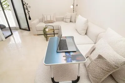 a laptop on a table in a living room at Luxurious studio Great location in Casablanca