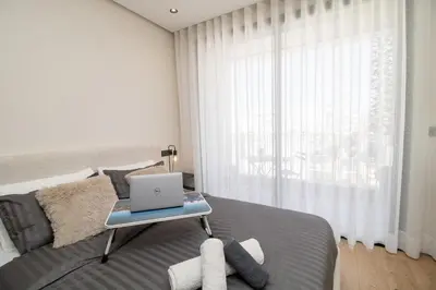 a bedroom with a bed with a laptop on a table at Luxurious studio Great location in Casablanca