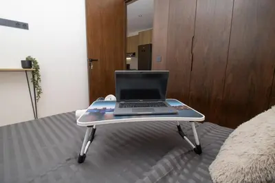 a laptop computer sitting on a tray on a bed at Luxurious studio Great location in Casablanca