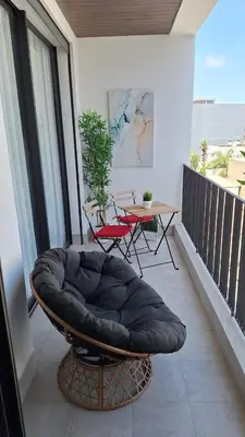 a balcony with a bean bag chair and a table at Luxurious studio Great location in Casablanca