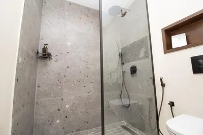 a shower with a glass door in a bathroom at Luxurious studio Great location in Casablanca