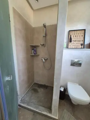 a bathroom with a shower and a toilet at Beach Villa with Private Pool, Ideal for Families in Casablanca