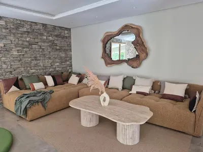 a living room with a couch and a table at Beach Villa with Private Pool, Ideal for Families in Casablanca