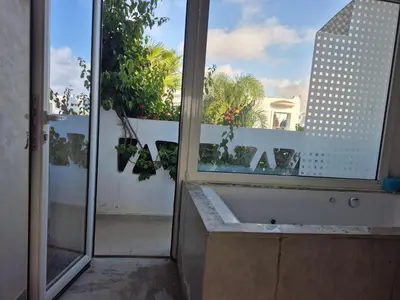 a bathroom with a bath tub and a window at Beach Villa with Private Pool, Ideal for Families in Casablanca