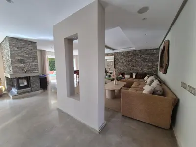 a living room with a couch and a fireplace at Beach Villa with Private Pool, Ideal for Families in Casablanca