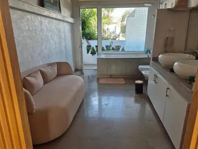 a living room with a couch and a sink at Beach Villa with Private Pool, Ideal for Families in Casablanca