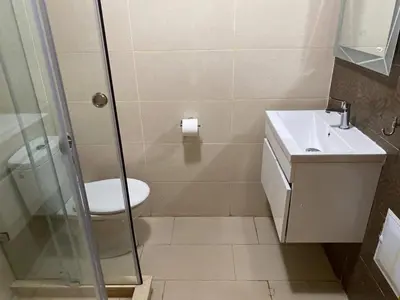 a bathroom with a shower and a toilet and a sink at Ola Blanca in Dar Hamida