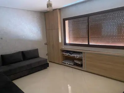 a living room with a couch and a flat screen tv at Villa pied dans l'eau in Sidi Rahal