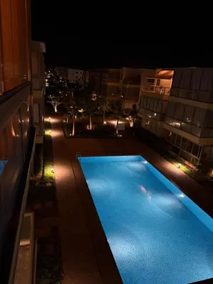 a view of a swimming pool at night at Blue Beach sidi rahal in Sidi Rahal