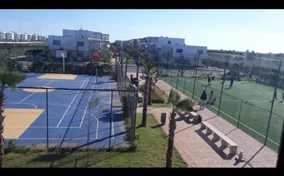 an overhead view of a tennis court with palm trees at Blue Beach sidi rahal in Sidi Rahal