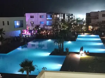 a view of a large pool at night at Blue Beach sidi rahal in Sidi Rahal