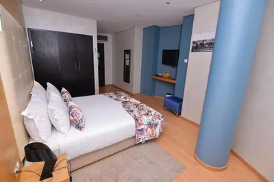 a bedroom with a bed and a blue pole at Le 135 appart hotel in Casablanca
