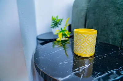 a yellow cup sitting on top of a table at R102-3-4 Amazing apartments in Belvedere with Breathtaking Ocean and Street Views in Casablanca