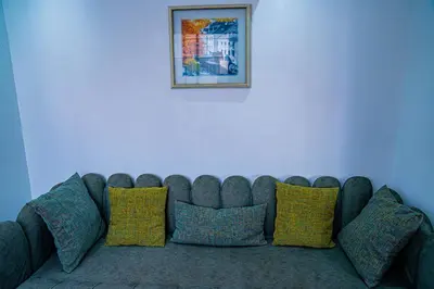 a couch against a white wall with a picture above it at R102-3-4 Amazing apartments in Belvedere with Breathtaking Ocean and Street Views in Casablanca