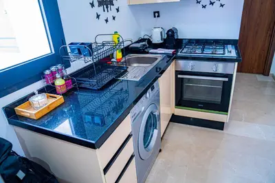 a kitchen with a sink and a washing machine at R102-3-4 Amazing apartments in Belvedere with Breathtaking Ocean and Street Views in Casablanca