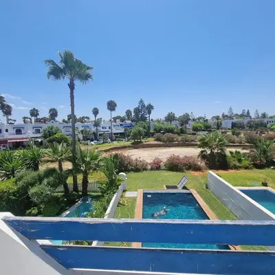 a view of the pool from the balcony of a resort at Private villa with pool in Bouznika