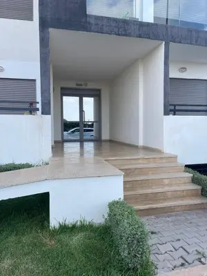 an external view of a house with stairs and a door at Cosy apartment in Bouznika in Bouznika