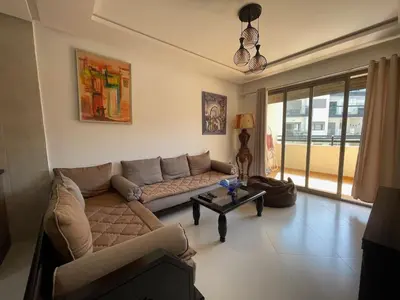 a living room with a couch and a table at Cosy apartment in Bouznika in Bouznika