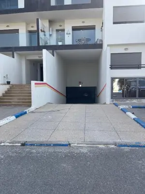 an empty parking lot in front of a building at Cosy apartment in Bouznika in Bouznika