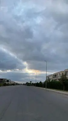 an empty street with buildings and a cloudy sky at Appartement à Ritaj Beach in Casablanca