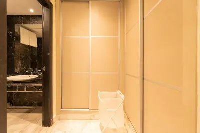 a bathroom with a glass shower door with a sink at Le yacht apartment II Oceanfront residence 2 BR 2 BA in Casablanca