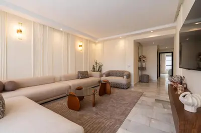 a large living room with a couch and a tv at Le yacht apartment II Oceanfront residence 2 BR 2 BA in Casablanca