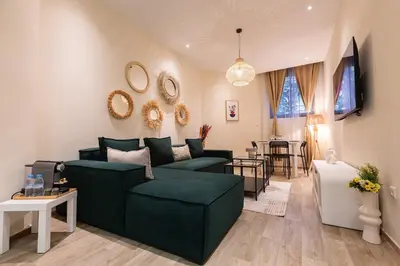 a living room with a green couch and a table at 2BR Apartment in Prestigious Mahaj Riad by MERAT HOME in Rabat