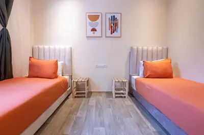 two beds sitting next to each other in a room at 2BR Apartment in Prestigious Mahaj Riad by MERAT HOME in Rabat