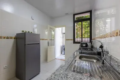 a kitchen with a sink and a refrigerator at 2BR Apartment in Prestigious Mahaj Riad by MERAT HOME in Rabat