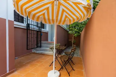 a yellow and white umbrella on a patio at 2BR Apartment in Prestigious Mahaj Riad by MERAT HOME in Rabat