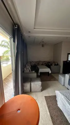 a living room with a couch and a table at Rayan beach Residence avec picine a tamaris in Tamaris