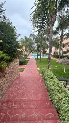 a red brick walkway leading to a swimming pool at Rayan beach Residence avec picine a tamaris in Tamaris