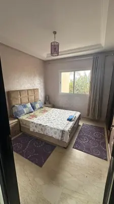 a bedroom with a large bed and a window at Rayan beach Residence avec picine a tamaris in Tamaris
