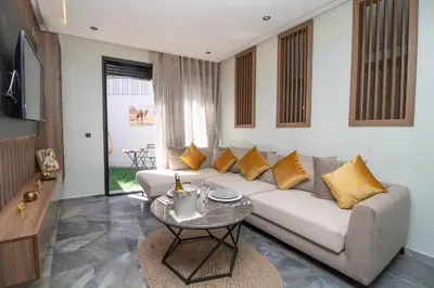 a living room with a couch and a table at Private terrasse and spa Studio Sahara in Casablanca in Casablanca