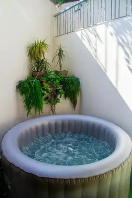 a hot tub in a balcony with potted plants at Private terrasse and spa Studio Sahara in Casablanca in Casablanca