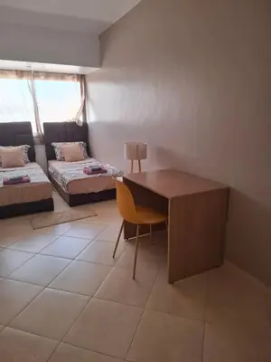 a living room with a desk and a couch at Apt 3 ch Casablanca 3 min Casa Voyageurs idéal pour une famille in Casablanca