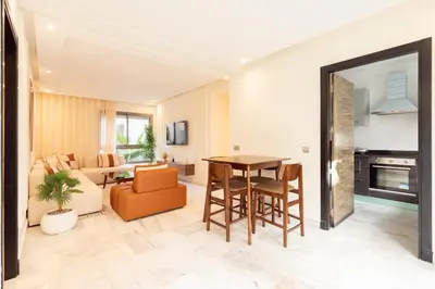 a living room with a table and a couch at Le yacht luxury apartment 2BR 2BA corniche with parking in Casablanca