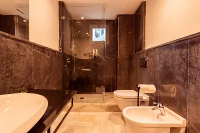 a bathroom with a sink and a toilet and a shower at Le yacht luxury apartment 2BR 2BA corniche with parking in Casablanca