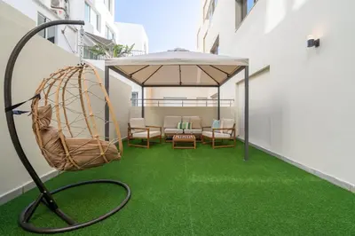 a hose on a balcony with green grass at Le yacht luxury apartment 2BR 2BA corniche with parking in Casablanca