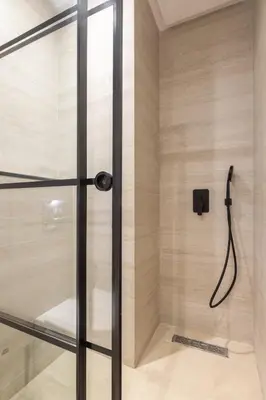 a shower with a glass door in a bathroom at Luxury 2 BR 2 BA Alsace Lorraine downtown in Casablanca