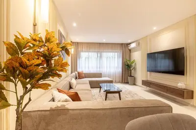 a living room with two couches and a flat screen tv at Luxury 2 BR 2 BA Alsace Lorraine downtown in Casablanca