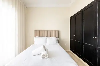 a bedroom with a bed with two pairs of shoes on it at cozy living, Chic 3BR appartement with parking! in Casablanca