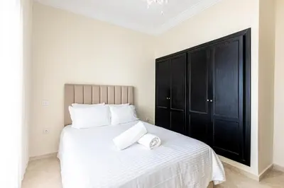 a bedroom with a large bed with two towels on it at cozy living, Chic 3BR appartement with parking! in Casablanca