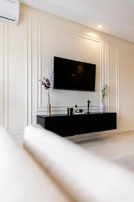 a living room with a flat screen tv on a wall at cozy living, Chic 3BR appartement with parking! in Casablanca