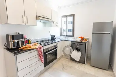 a kitchen with a refrigerator and a washer and dryer at The Loft Residence by GoodMove - Maarif Casablanca in Casablanca