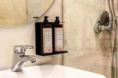 a bathroom sink with two soap bottles on a shelf at The Loft Residence by GoodMove - Maarif Casablanca in Casablanca